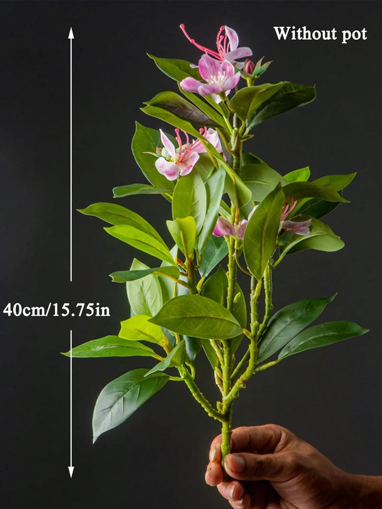 Hand holding artificial azaleas indoor decor branch measuring 40cm with vibrant pink flowers and green leaves