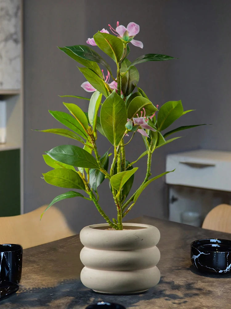 Stylish artificial azaleas indoor decor in a beige ceramic pot for home styling