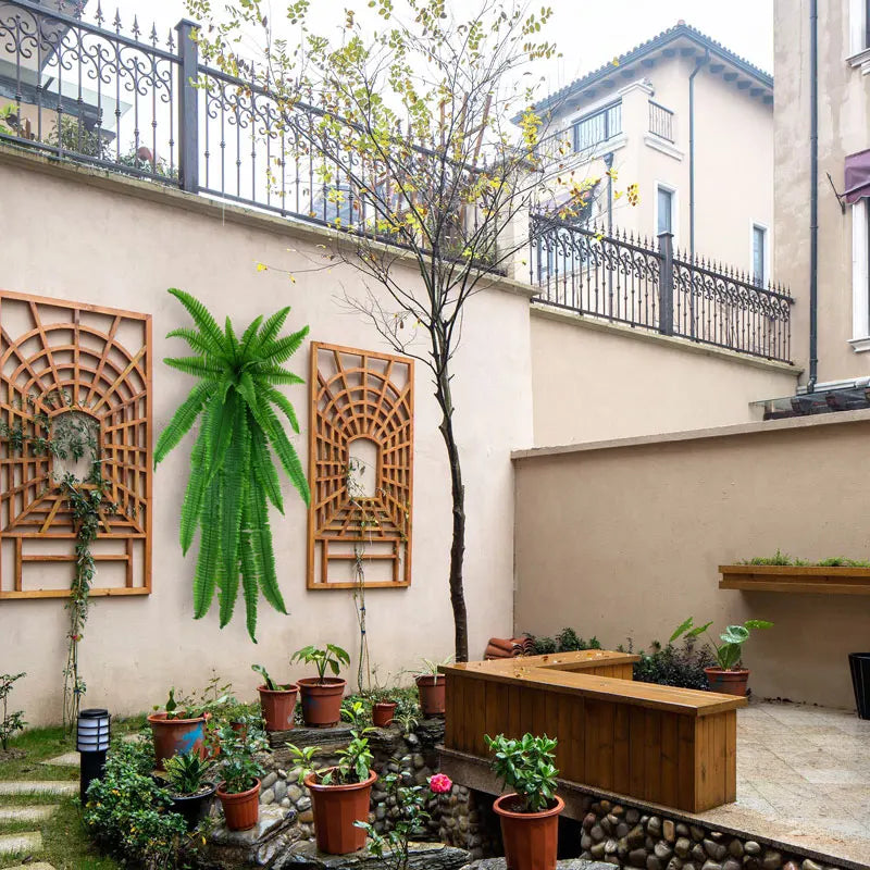 Lush green indoor plants in a decorative patio area featuring wooden accents and modern design