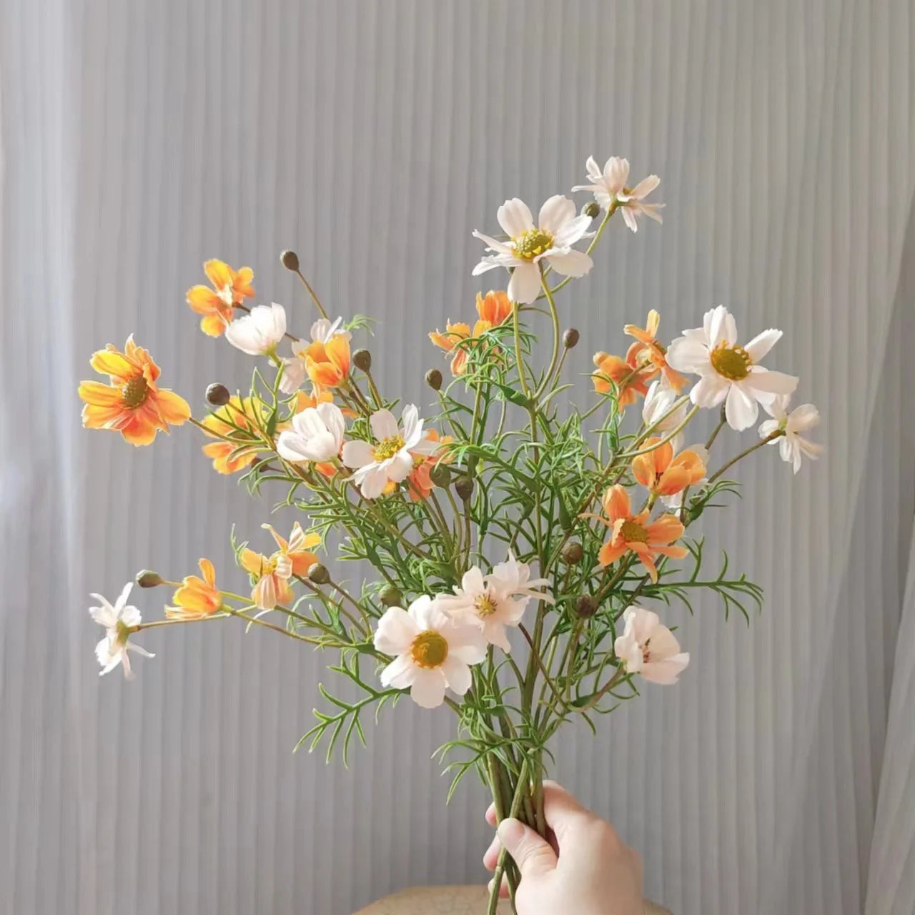 Artificial flower bouquet featuring white and orange daisies for home decor and gifting