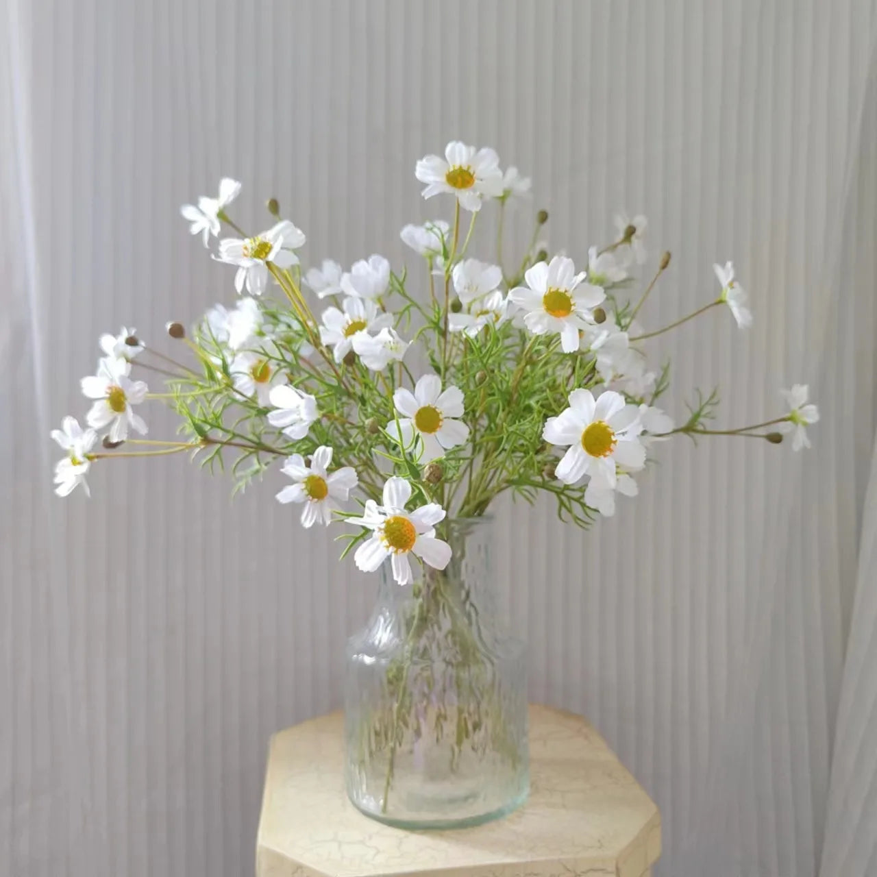 Fresh white daisy bouquet in a glass vase, perfect for home decoration