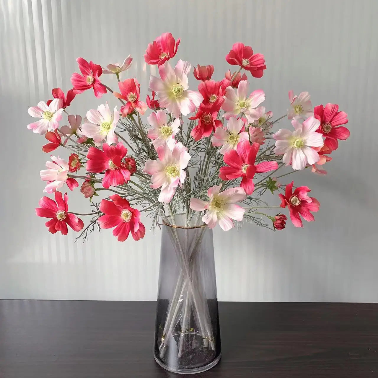 Beautiful artificial pink and white flowers in a clear vase for home decor or events