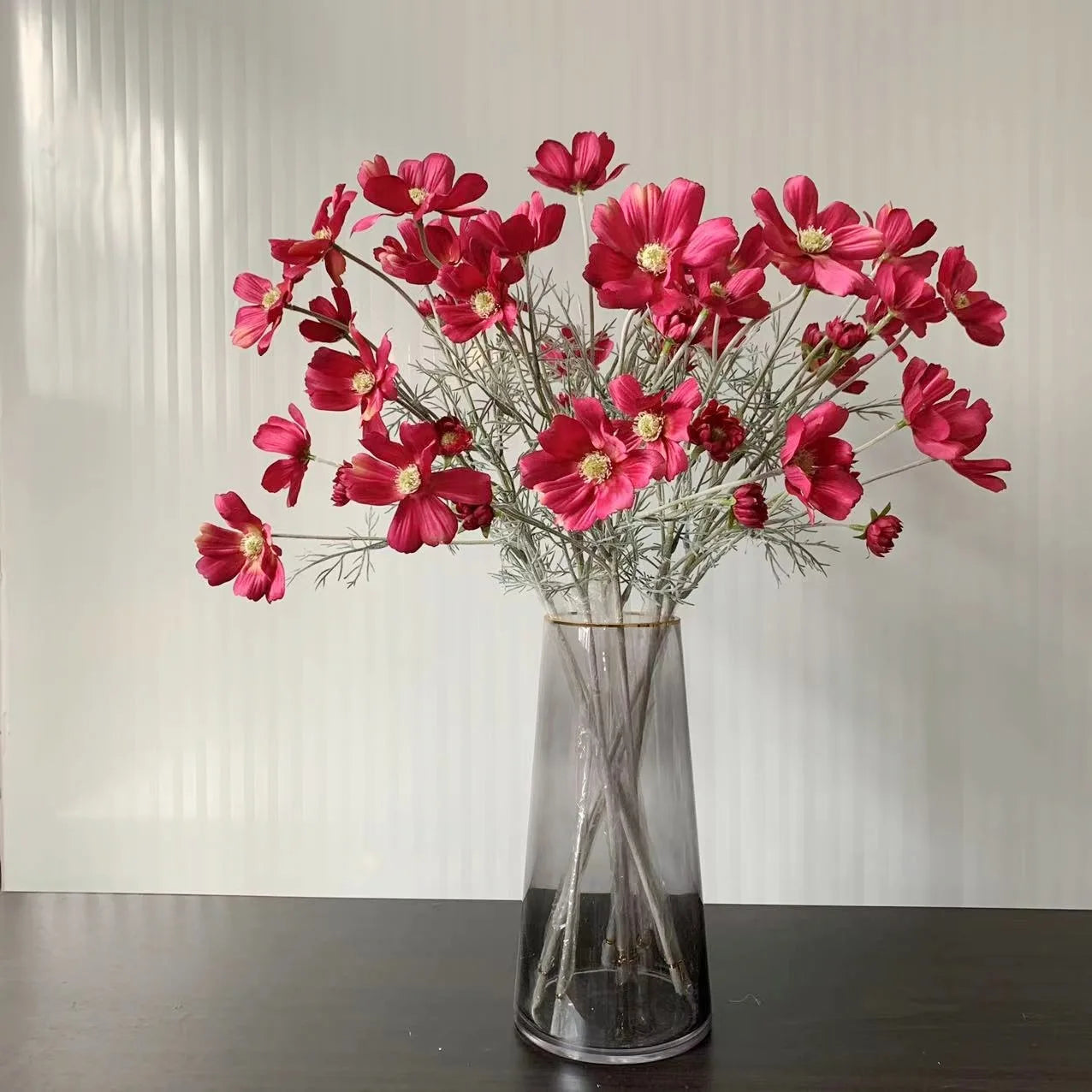 Artificial pink cosmos flower bouquet in a clear glass vase for home decor