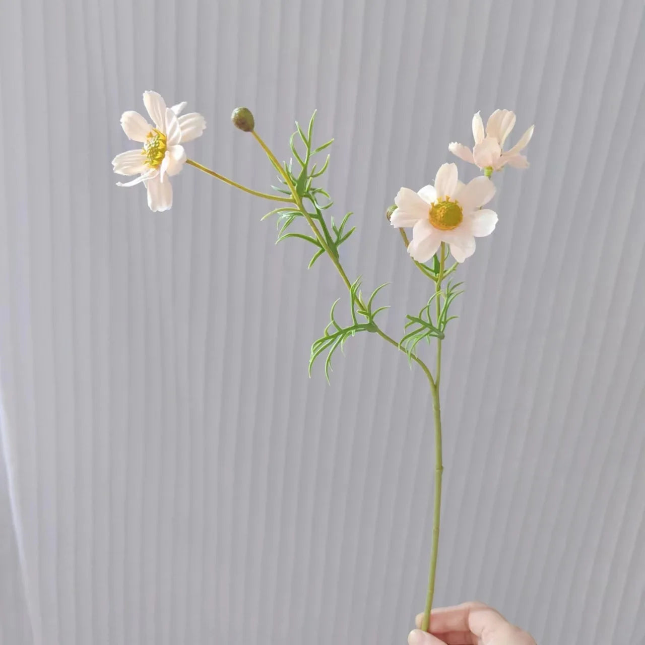 Artificial pink daisy flower stem with realistic petals and green leaves