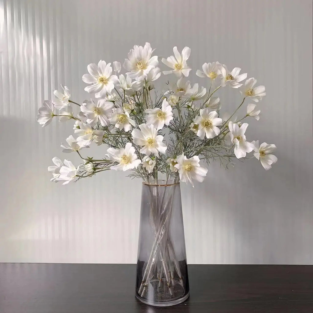 Elegant white artificial flowers in a stylish gray vase for home decor