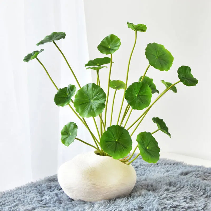 Artificial lotus plants for home decor in a stylish vase with green leaves and a modern base
