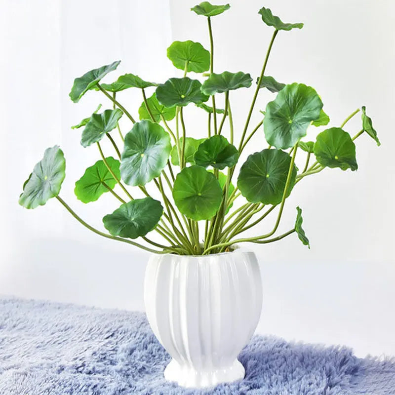 Beautiful artificial lotus plants for home decor in a white vase with lush green leaves