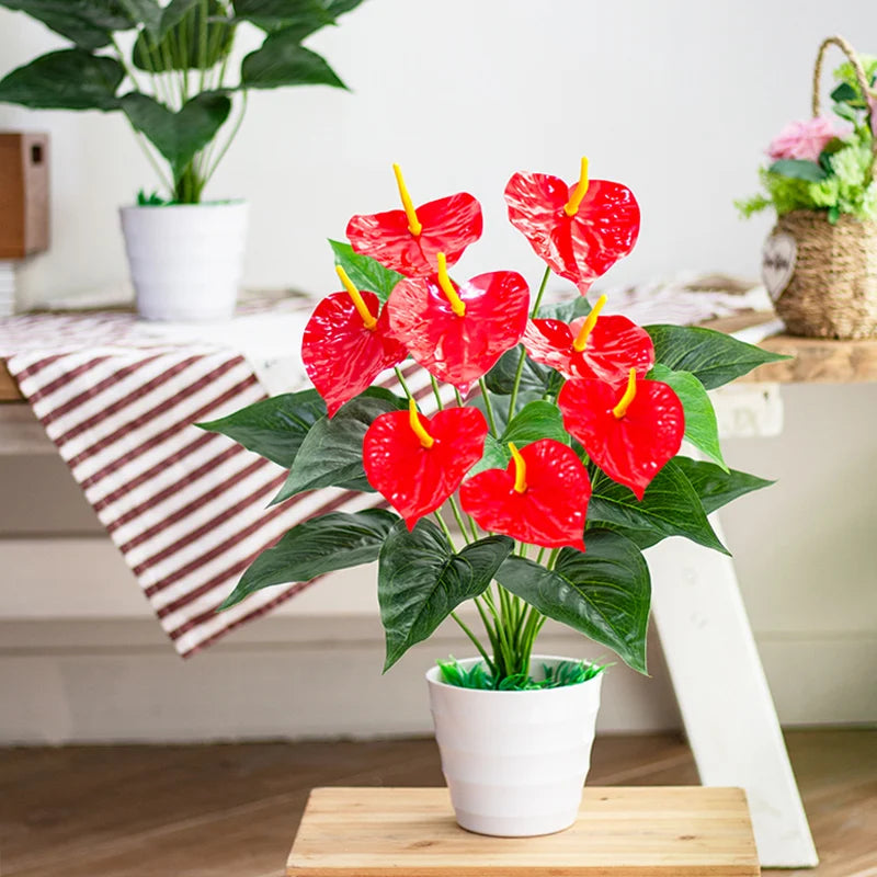 Artificial red anthurium plant in white pot with vibrant leaves for home decor