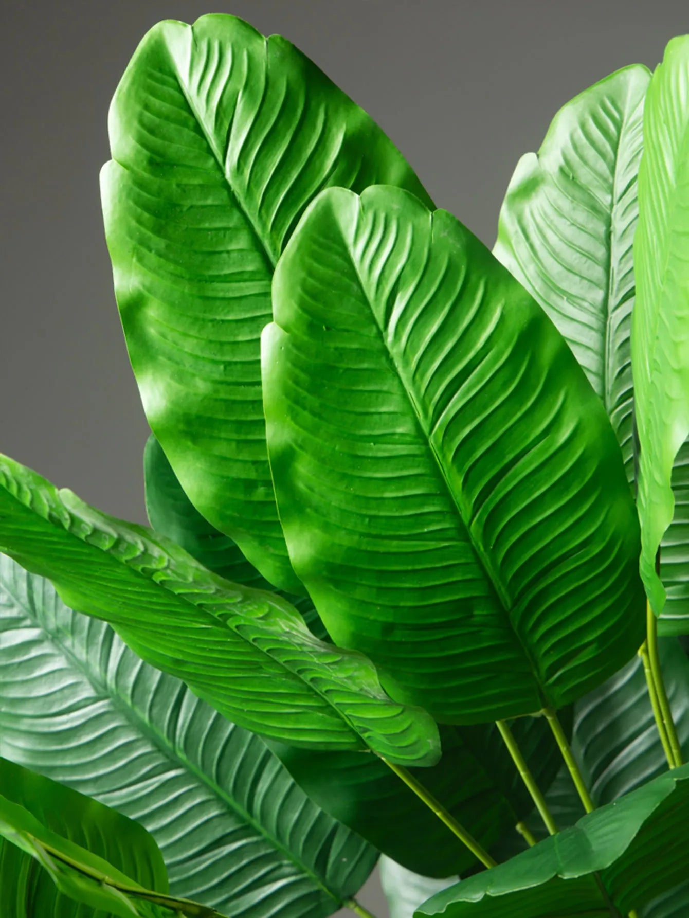 Lush green artificial palm leaves with detailed ribbed texture for vibrant home decor