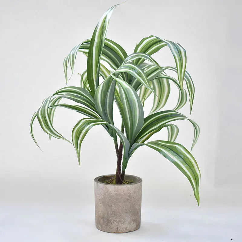 Artificial striped green plant in a modern gray pot for home decoration