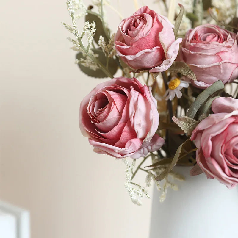 Artificial rose bouquet autumn in a white vase featuring soft pink roses and green foliage