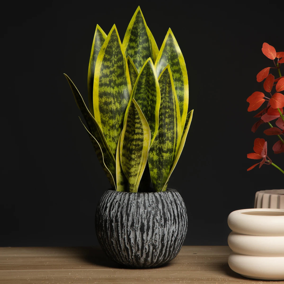 Artificial snake plant decor in a textured pot, perfect for adding greenery to any space