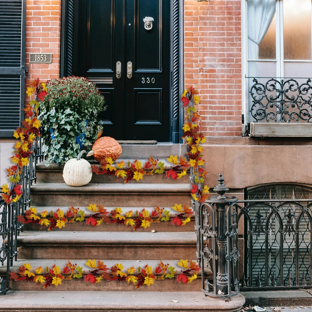 Fall-themed doorstep with colorful leaves, pumpkins, and potted plants for autumn decoration