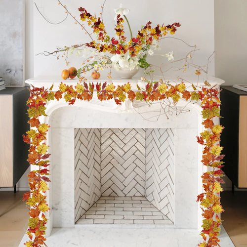 Elegant marble fireplace adorned with autumn leaf garland and floral arrangement for seasonal decor