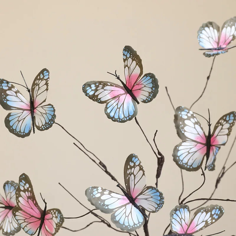 Colorful decorative butterfly ornaments on a branch for home and event decoration