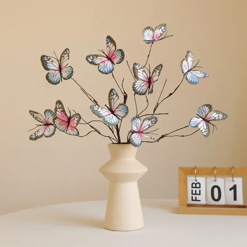 Artificial butterfly flower arrangement in a cream vase for stylish home decor