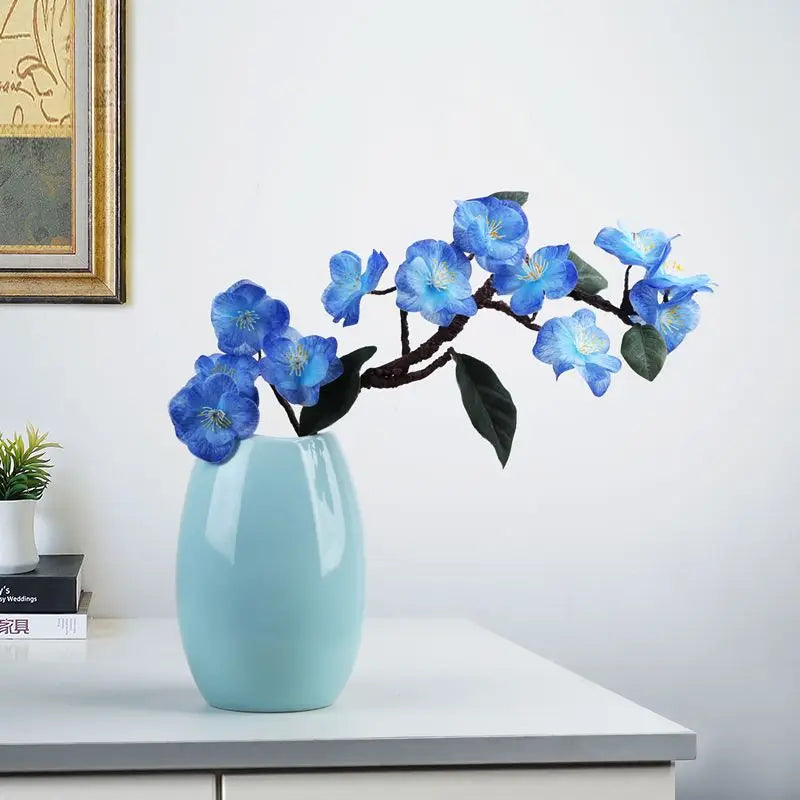 Elegant blue artificial orchid arrangement in a light blue vase for home decor