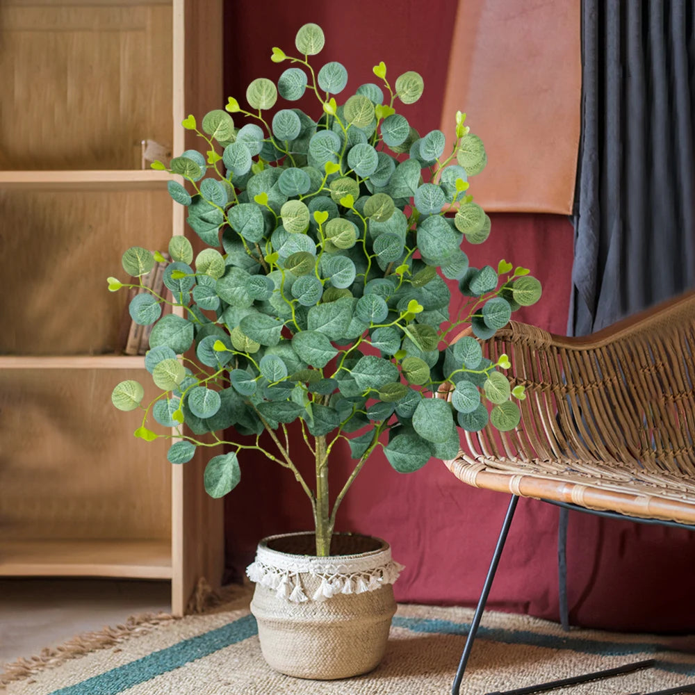Artificial decorative tree with green leaves in a woven pot for home styling