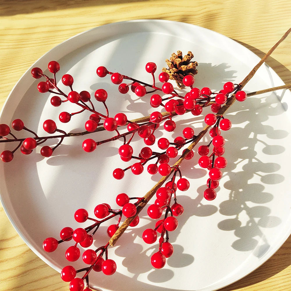 Artificial red berry branches on a white plate, perfect for holiday decor and floral arrangements