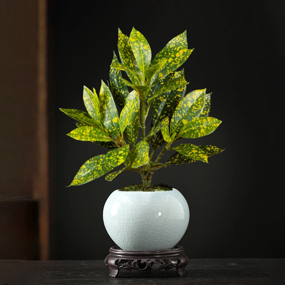 Decorative artificial potted plant with vibrant green leaves in a ceramic pot