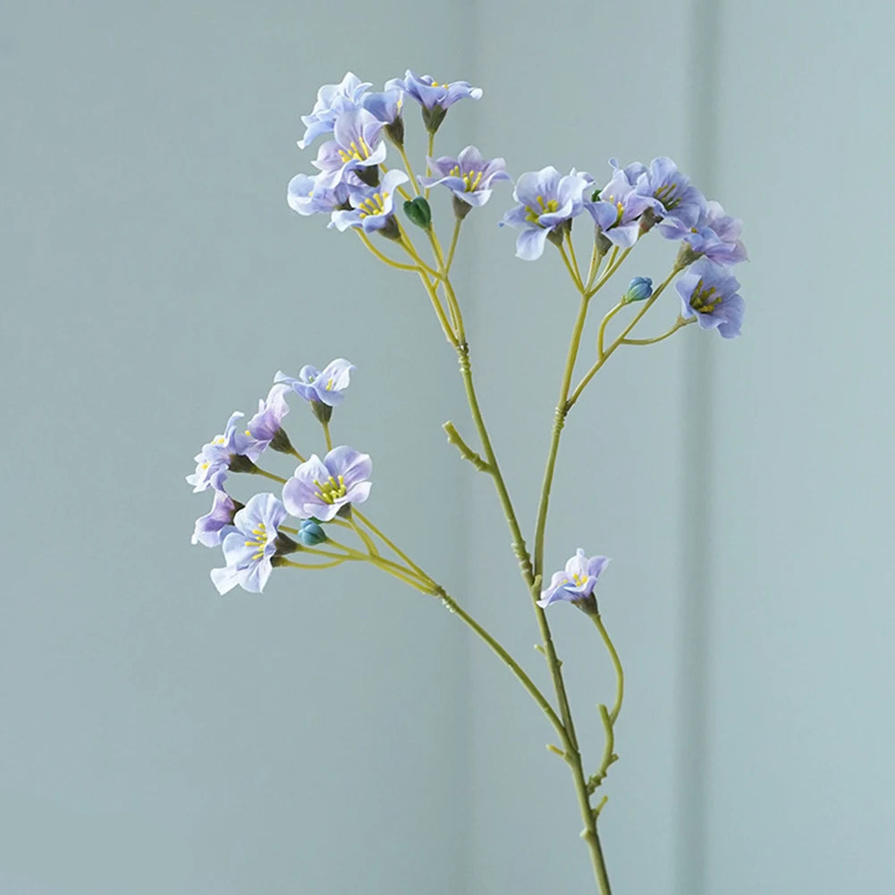 Delicate purple fake flower table decorations with lifelike petals and slender stems