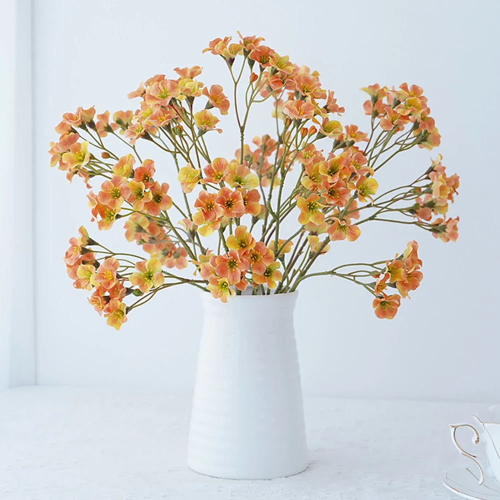 Elegant vase with orange fake flower table decorations adding charm to any room
