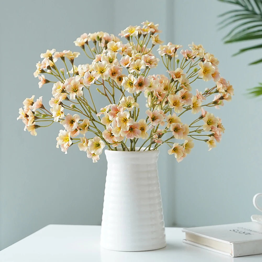 Charming fake flower table decorations in a white vase for a fresh and inviting look