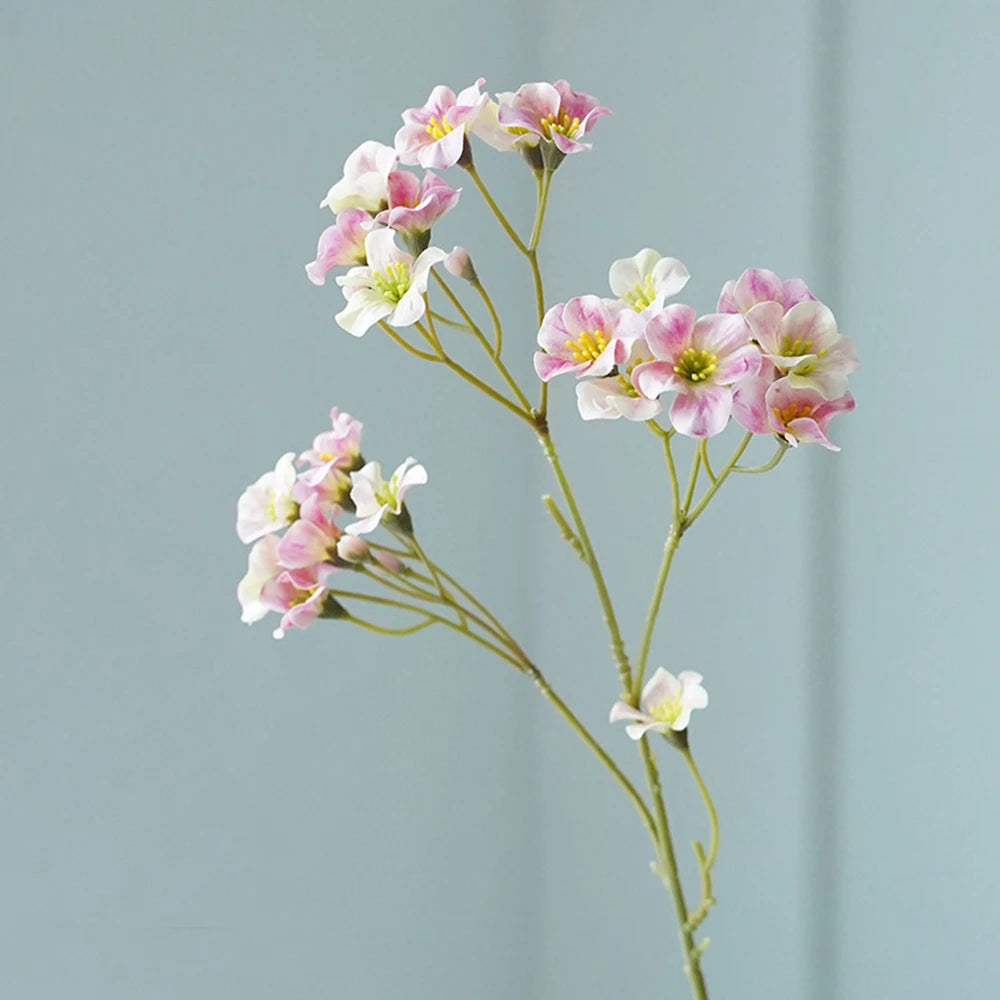 Delicate pink and white fake flower table decorations for a charming home accent