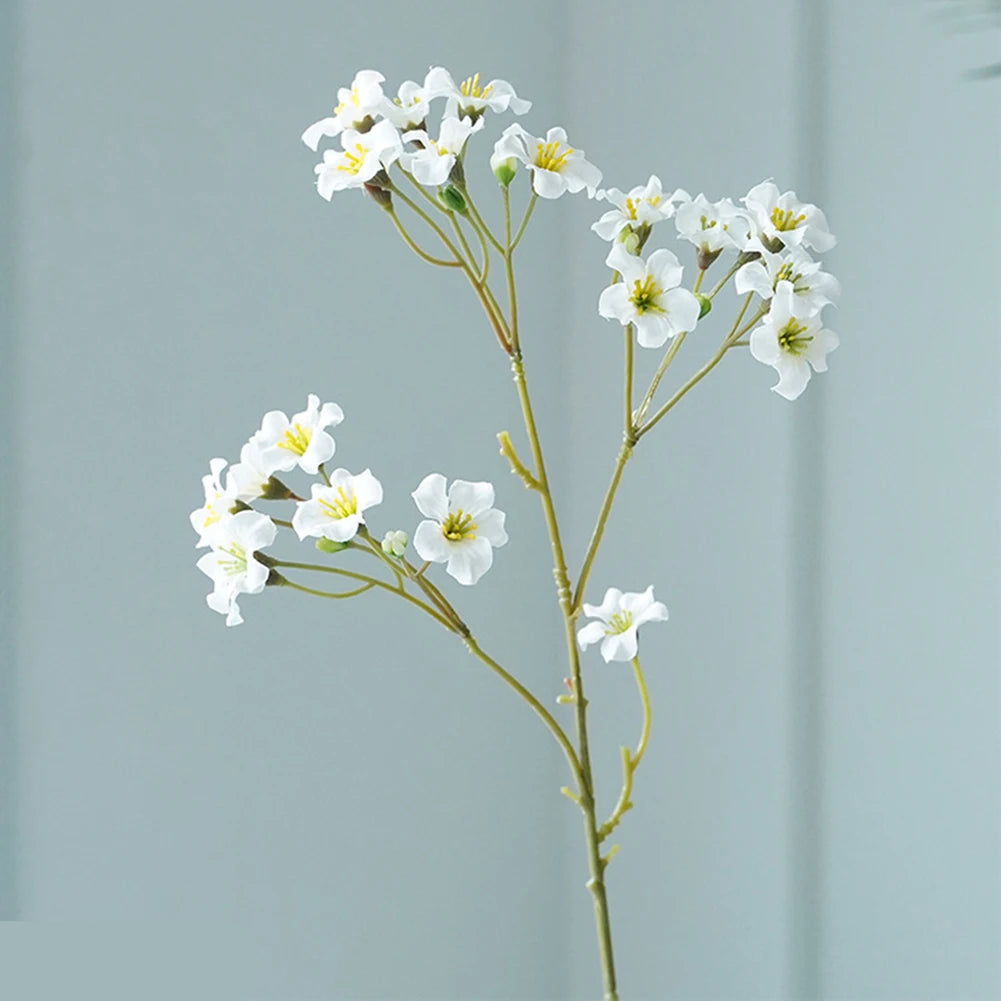 Elegant white fake flower table decorations featuring delicate blossoms on a slender stem