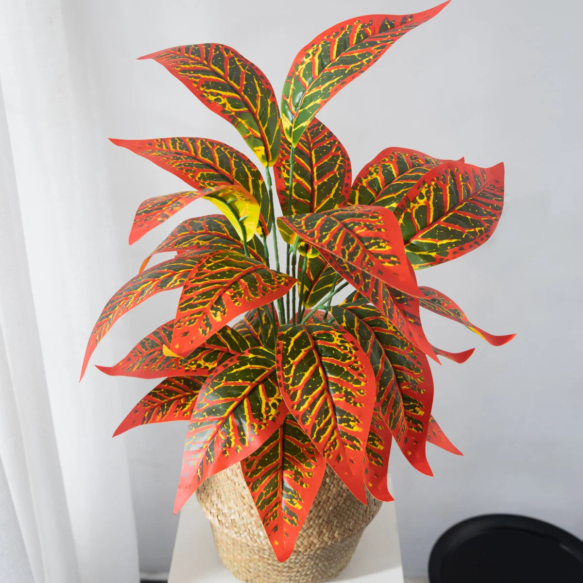 Colorful faux plant arrangement in a woven basket, ideal for home interiors as fake magnolia branch decor