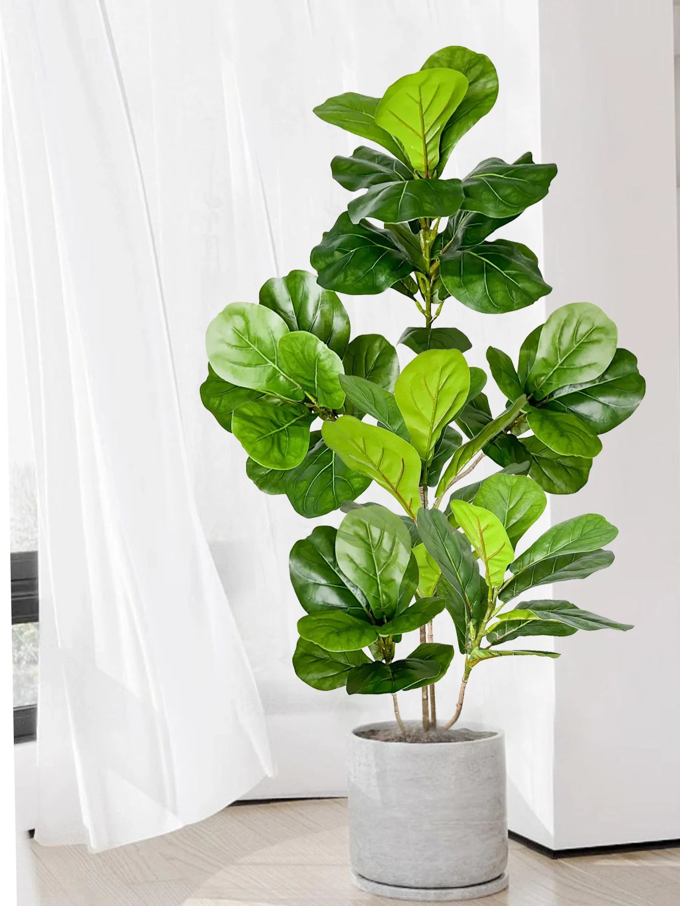 Stylish fake rubber plants for decor in a modern gray planter, enhances indoor aesthetics