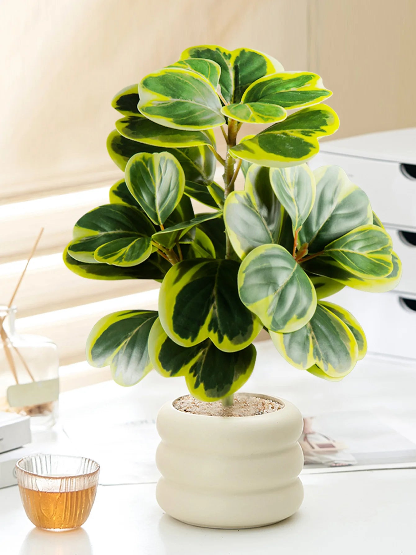Fake succulent home decor in a modern white pot with vibrant green and yellow leaves