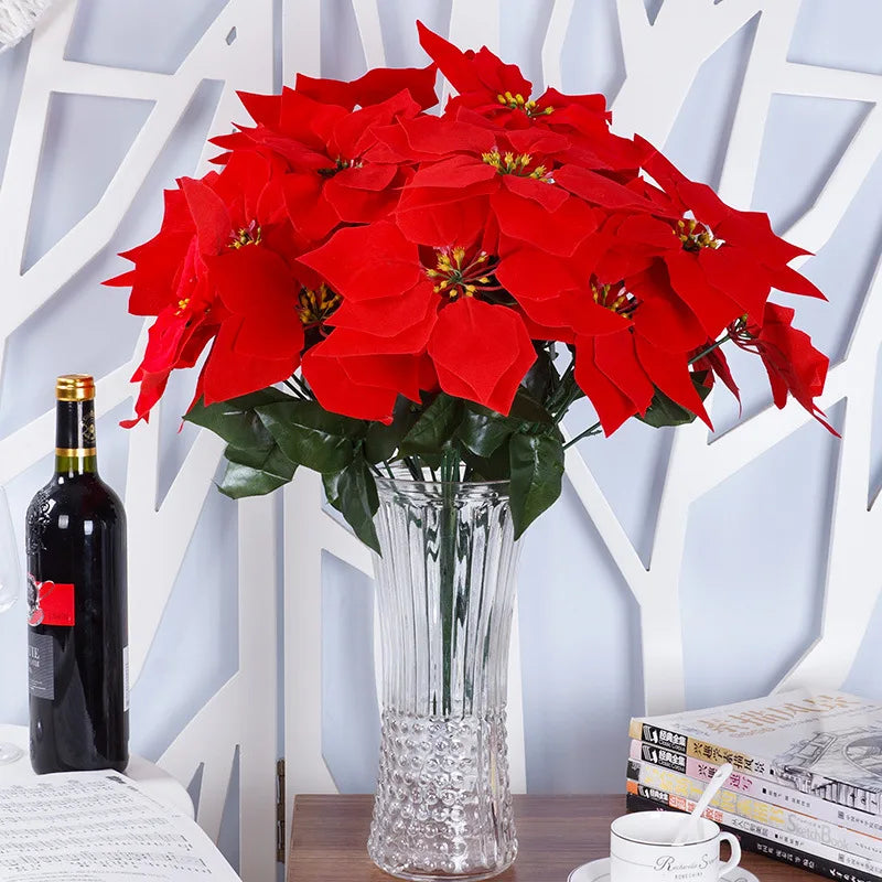 Artificial red poinsettia flowers in a clear glass vase, perfect for home decoration
