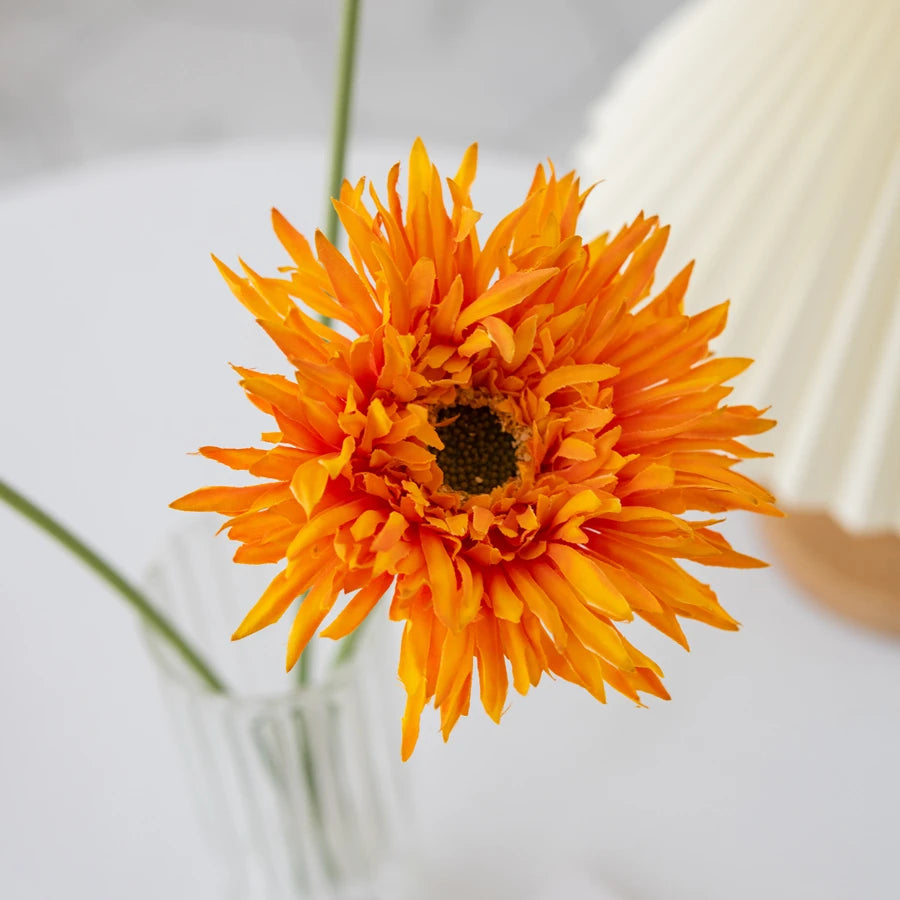 Vibrant orange Gerbera artificial flower 2025 in a clear vase for home decor