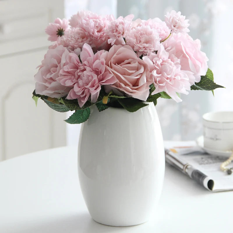 Elegant faux pink flower arrangement in a white ceramic vase for home decor