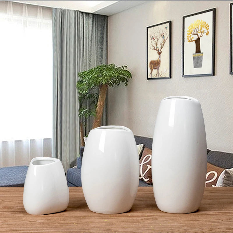 Set of three white ceramic vases in varying heights for home decoration and styling