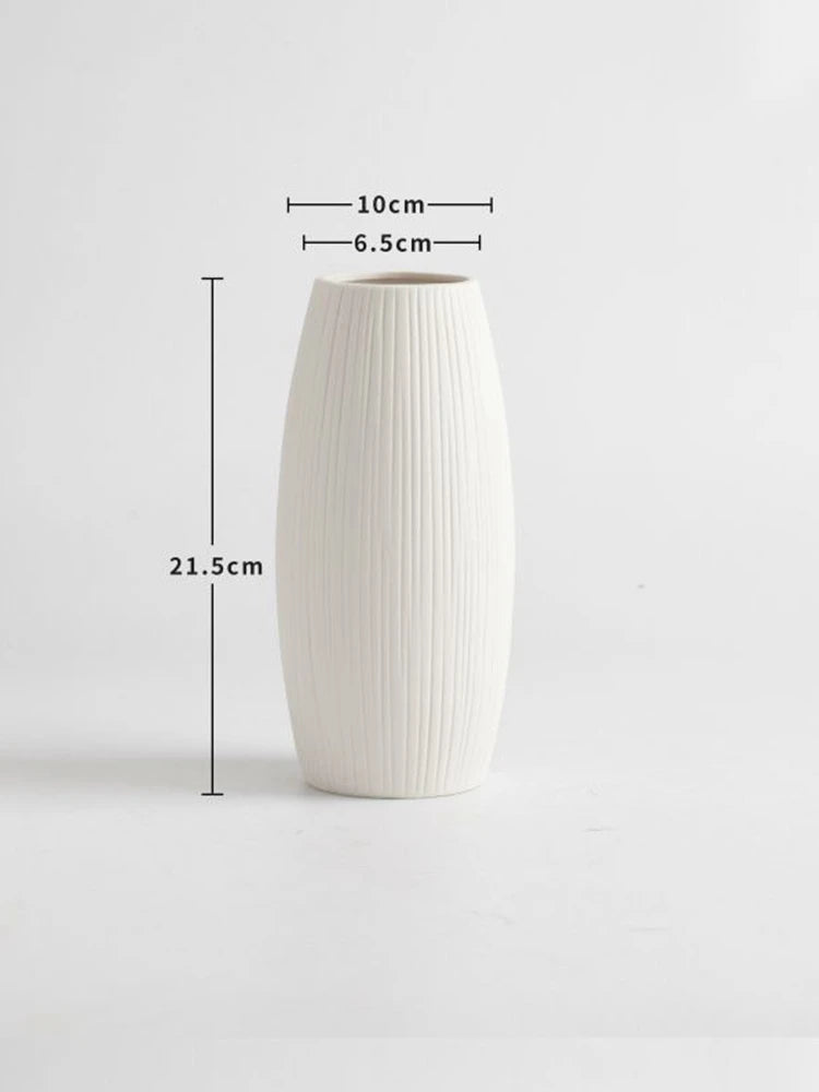 Elegant white ceramic jarrones for home decoration, featuring a ribbed texture and stylish design