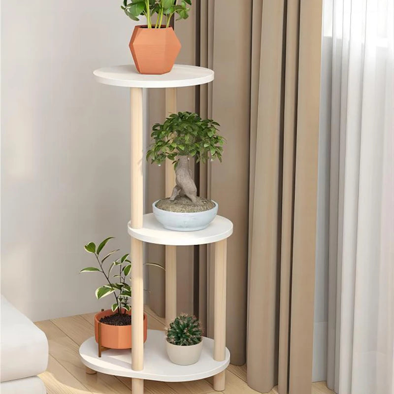Modern living room flower rack with three tiers showcasing various potted plants in a stylish interior