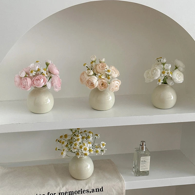 Set of three modern mini flower vases with pastel roses and daisies for home decor