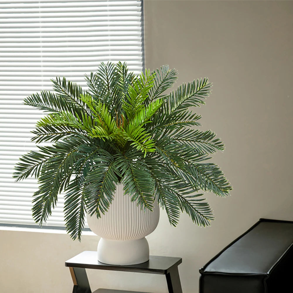 Artificial palm plant in a white ribbed pot for modern home decor