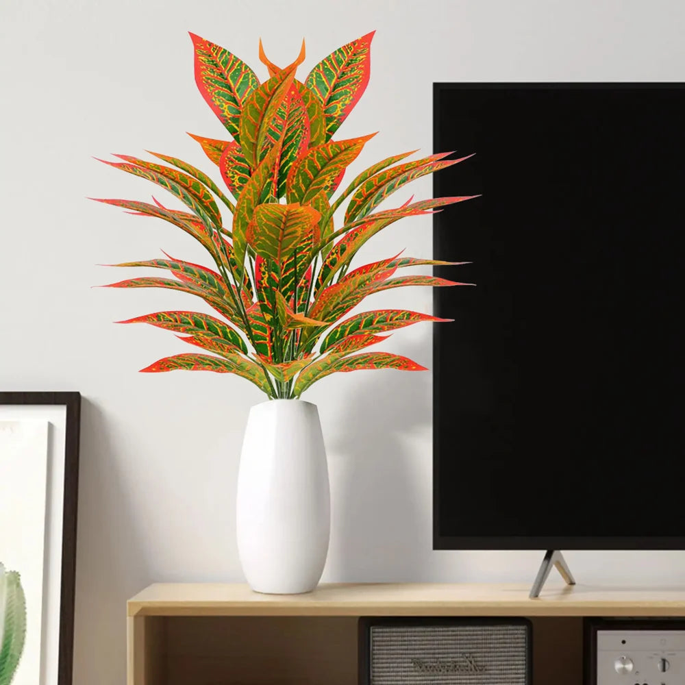 Vibrant artificial foliage in a white vase, adding color to modern decor