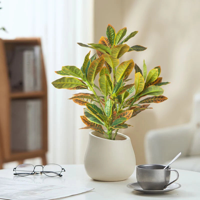  artificial Croton plant in a modern pot adding greenery to a stylish living space