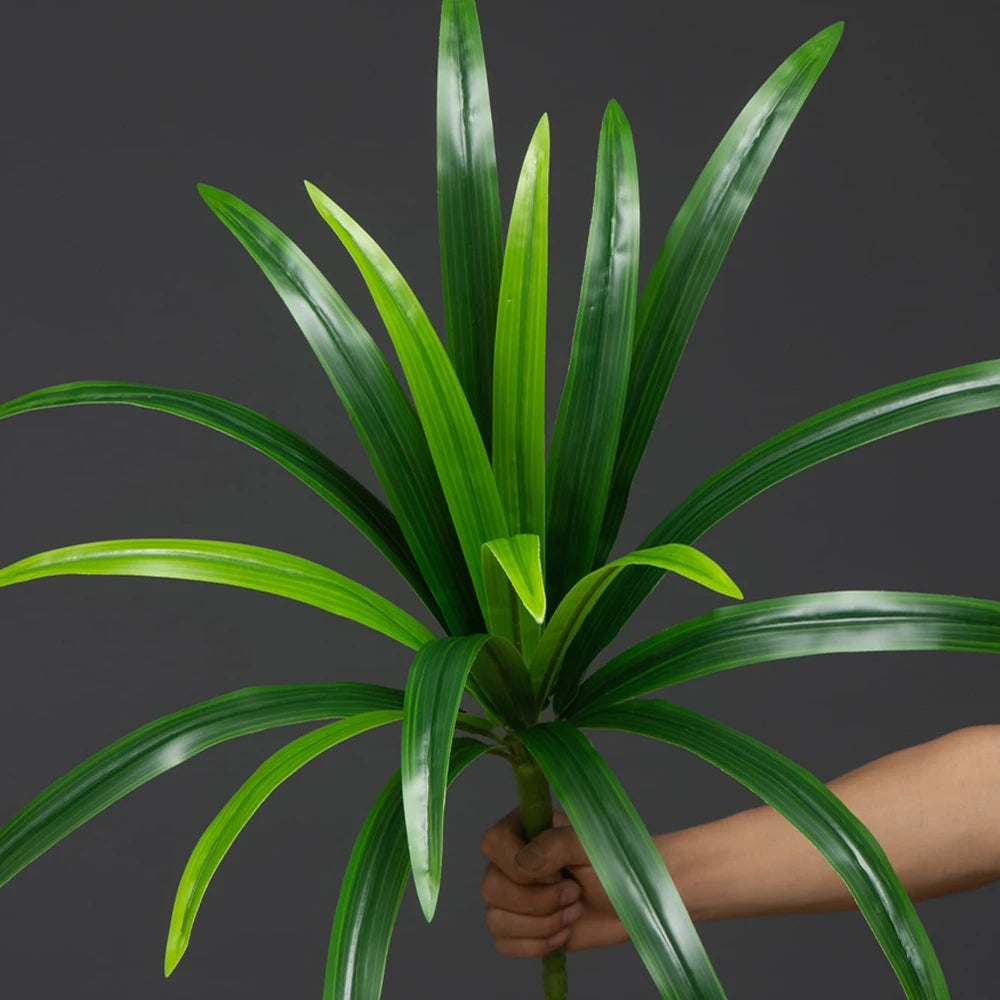 Artificial green potted plant with long, vibrant leaves for indoor decoration