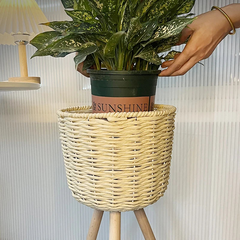Stylish plant holder from Mağazam featuring a woven design and a potted green plant