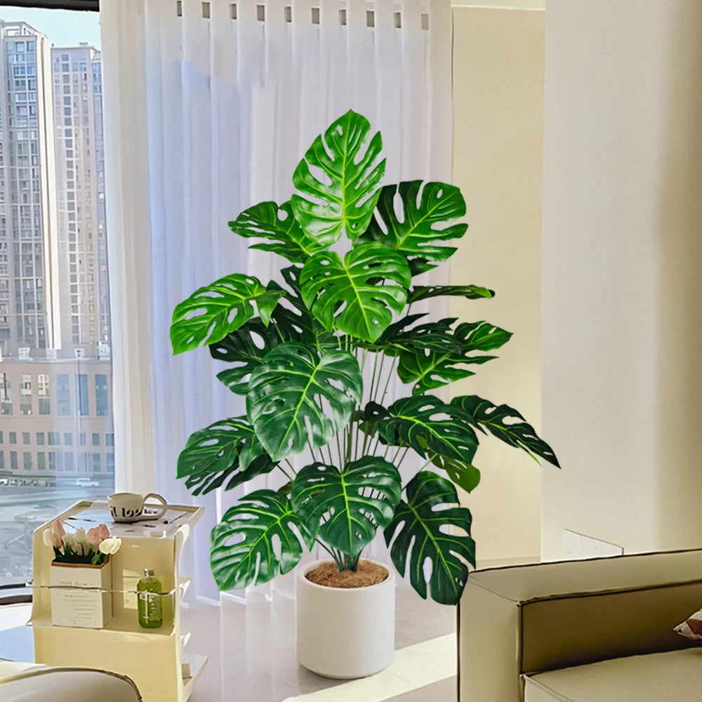 Plastic turtle leaf indoor plant in white pot with vibrant green foliage in a modern living space