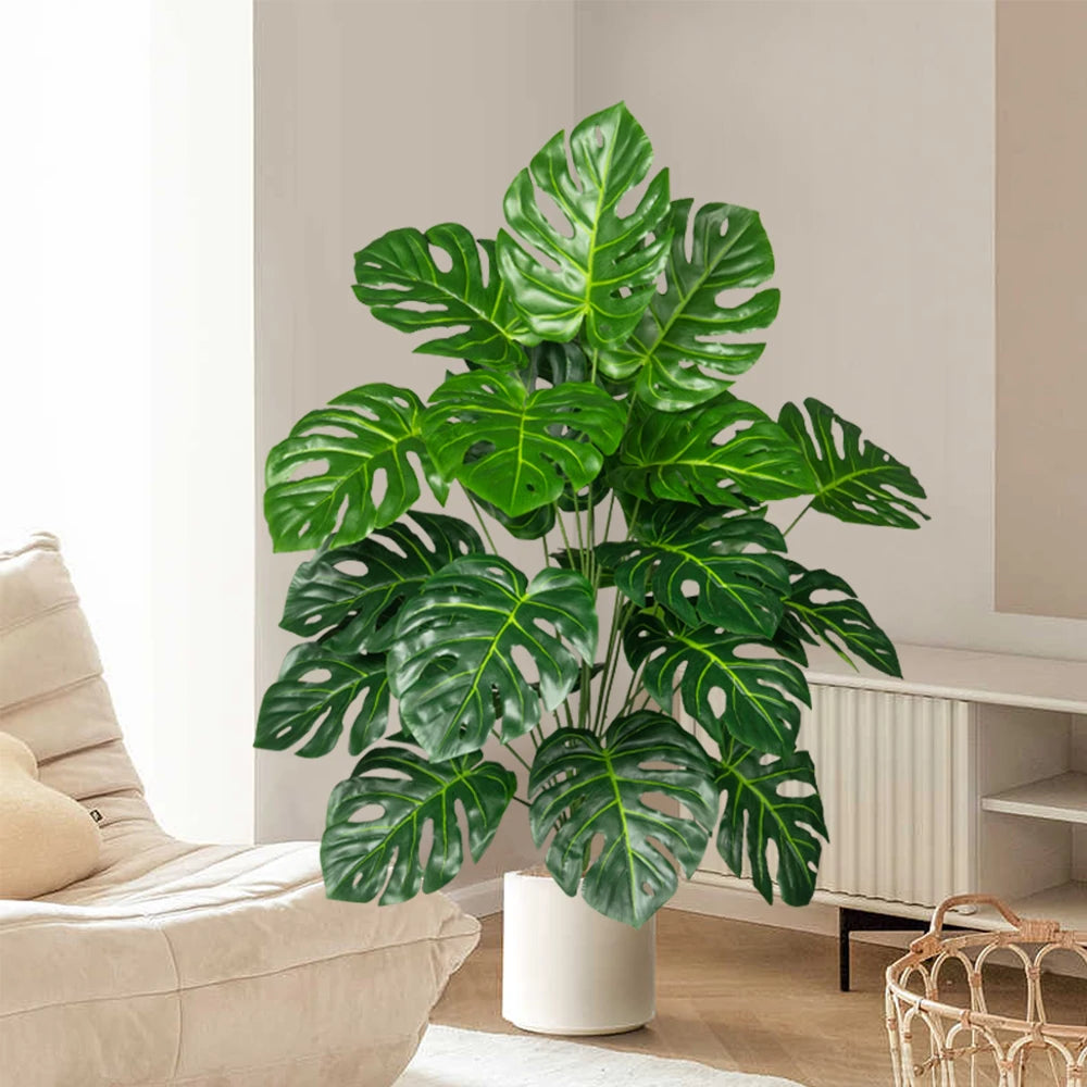 Plastic turtle leaf indoor plant in a stylish white pot, adding greenery to home decor