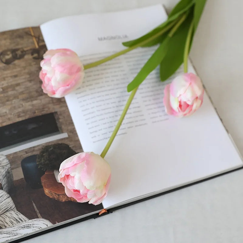 Artificial Pink and White Tulip Flowers on an Open Book Page for Home Decor