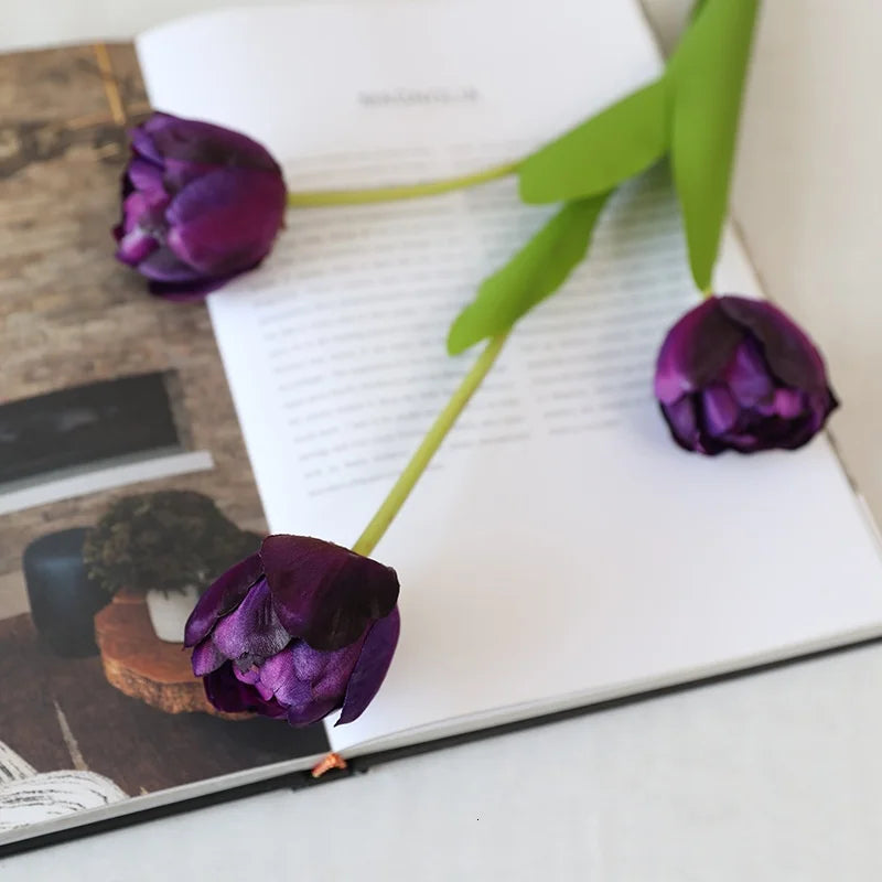 Artificial Purple Tulip Flowers on a Book Page for Home Decor Enthusiasts