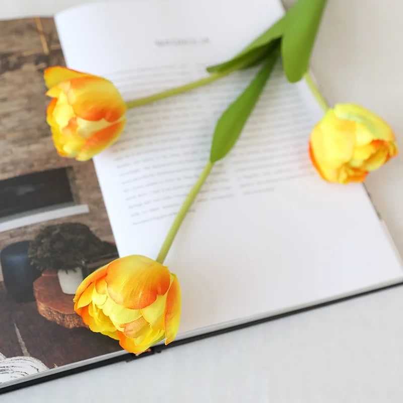 Artificial Yellow and Orange Tulips for Home Decor on a Open Book