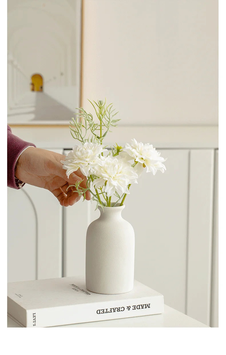 Elegant white ceramic vase with fresh flowers, perfect for home decor by Mağazam